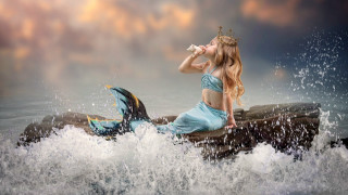 Woman blue dress rock ocean - a dolphin free wallpaper