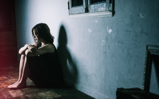 Woman sitting red light room - liminal free wallpaper for desktop