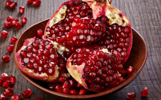 Pomegranates wooden table red fruit - scattered free wallpaper