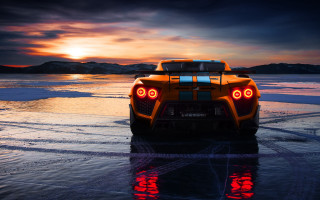 Sports car beach sunset reflection - a sports car free wallpaper