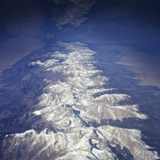 Mountain range airplane window sky - free mountains wallpaper for tablet