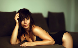 Woman black dress couch laying 2 - prima free wallpaper