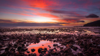 Sunset rocky beach puddle mountain - the foreground and a mountain in the background free wallpaper
