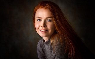 Woman red hair smiling dark - a black backdrop free wallpaper
