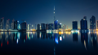 City skyline night water reflection 4 - a large body of water in front free wallpaper