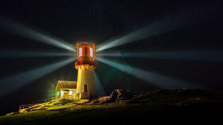 Lighthouse night stars light beam - a lighthouse free wallpaper