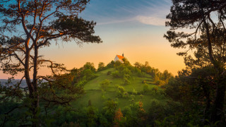 Hill flag trees bushes autumn - orange sky free wallpaper