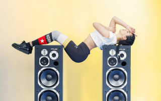 Woman handstand speakers yellow background - a handstand free wallpaper