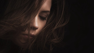 Woman blowing hair portrait dark - the wind free wallpaper