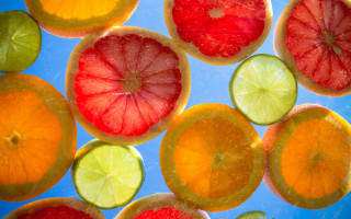 Citrus fruit slices blue surface - a blue surface free wallpaper