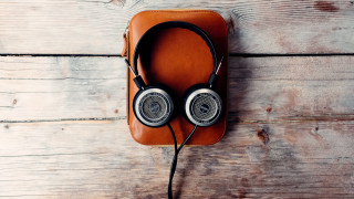 Headphones brown case wooden floor - a cord free wallpaper