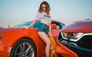 Woman leaning on car crossed - the hood of a car free wallpaper
