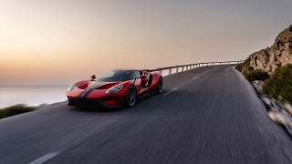 Red sports car cliff ocean 2 - a bridge in the background free wallpaper