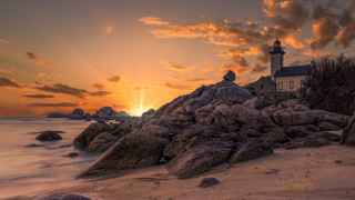 Lighthouse rocky shore sunset clouds 16 - a lighthouse free wallpaper