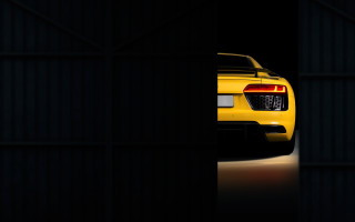 Yellow sports car dark doorway - a black wall free wallpaper