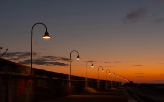 Street lights wall sunset clouds - a concrete wall free wallpaper