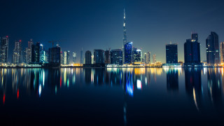 City skyline night water reflection 10 - a large body of water in front free wallpaper