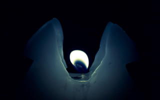 Lit candle dark moonlight night - a candle free wallpaper