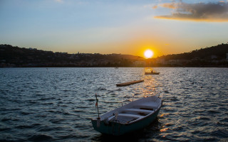 Sunset boat water landscape island - the water and a boat free wallpaper