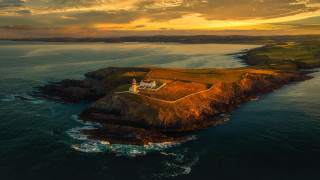 Lighthouse island ocean sunset clouds 2 - radiant free wallpaper for desktop