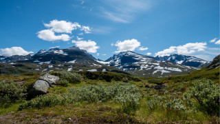 Mountain range snow capped grassy - a few snow free wallpaper