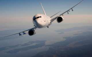 Large jetliner flying blue sky - turnaround free wallpaper