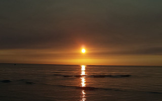 Sunset ocean boat beach person - the beach in the foreground free wallpaper