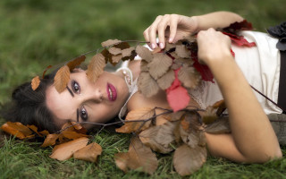Woman lying grass leaves hair - black tie free wallpaper