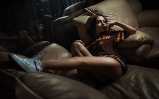 Woman sitting couch basketball shoe - her foot free wallpaper