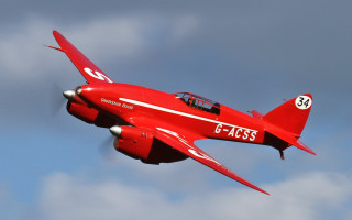Red fighter jet cloudy sky - a cloudy blue sky free wallpaper