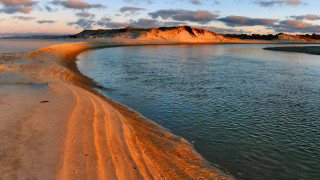 Sandy beach water hill clouds - a sandy beach free wallpaper