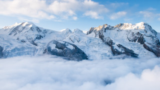 Snowy mountain range blue sky 15 - a few cloud below free wallpaper for desktop