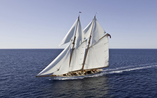 Sailboat open ocean sunny day - below free wallpaper