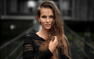 Woman longhair building fence bokeh - a black fence free wallpaper