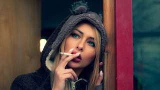 Woman hoodie smoking window portrait - a cigarette free wallpaper