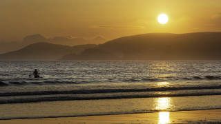Surfing sunset mountains beach moon - the background and a person free wallpaper