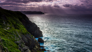 Cliff water island mountain sunset - a small island in the distance free wallpaper