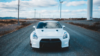 White sports car gravel road 2 - a white sports car free wallpaper