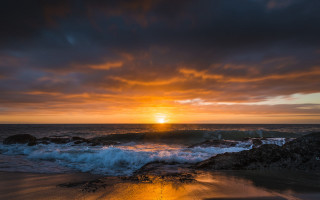 Sunset ocean waves beach distant 3 - the shore and a person free wallpaper