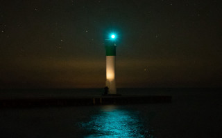 Lighthouse green light night stars 2 - bioluminescence free wallpaper