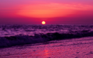 Sunset ocean surf wave beach - a sunset over the ocean free wallpaper