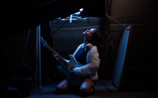 Woman playing guitar dark room - above her head free wallpaper