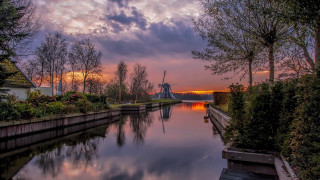 River boat clouds trees buildings - both side free wallpaper