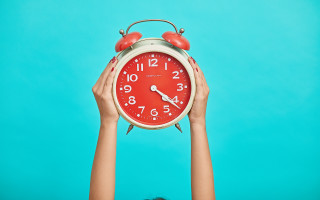 Person holding red clock blue - the clock free wallpaper