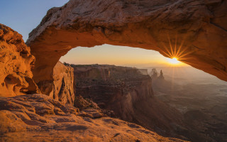 Sunset arch rock formation orange - a large rock formation free wallpaper