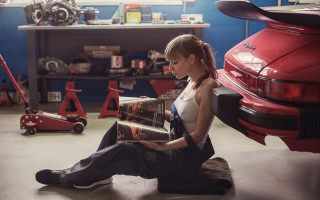 Woman sitting garage reading car - feminist free wallpaper for desktop