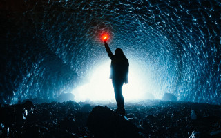 Cave person red light water - a dark cave free wallpaper