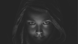 Hooded woman nosepiercing blackbackground photorealistic - a hood free wallpaper