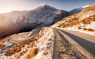 Snowy mountain road sunset ocean - mountain range free wallpaper