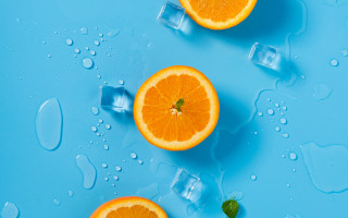 Three oranges on ice cubes - the surface free wallpaper